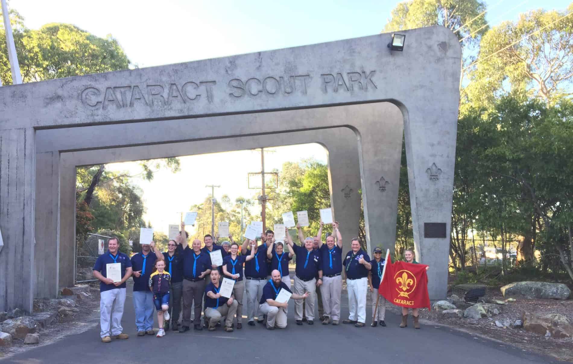 Cataract Scout Park entrance with Scouts holding papers infront